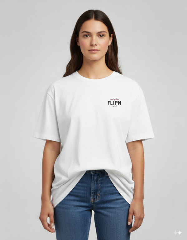 "Female model wearing a white unisex FLIPN graphic t-shirt with small black and red logo text on the chest, paired with blue jeans."